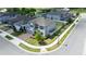 Aerial view of a gray home situated on a corner lot, featuring a well-kept lawn and brick driveway at 2090 Prairie Sage Ln, Longwood, FL 32750