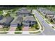 An aerial view of a gray house showcases the brick driveway, manicured lawn, and neighborhood setting at 2090 Prairie Sage Ln, Longwood, FL 32750