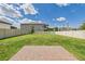 Spacious backyard with a well-maintained lawn, a brick patio, and a white fence surrounding the perimeter at 2090 Prairie Sage Ln, Longwood, FL 32750