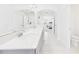 Modern bathroom with double vanity, tile flooring, and archway leading to the bedroom at 2090 Prairie Sage Ln, Longwood, FL 32750