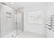 Bright bathroom featuring glass enclosed shower, linen closet, and a window for natural light at 2090 Prairie Sage Ln, Longwood, FL 32750