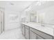 Well-lit main bathroom with double vanity, a glass-enclosed shower, and tile flooring at 2090 Prairie Sage Ln, Longwood, FL 32750