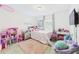Cozy bedroom with soft carpet, fun decor, and natural light, creating a playful and inviting atmosphere at 2090 Prairie Sage Ln, Longwood, FL 32750
