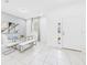 Bright dining area with a glass table, white chairs and bench, and stylish decor creating an elegant space at 2090 Prairie Sage Ln, Longwood, FL 32750