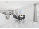 Dining area featuring a modern table and chairs adjacent to a bright and airy kitchen with stainless appliances at 2090 Prairie Sage Ln, Longwood, FL 32750