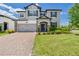 Charming two-story home with a well-manicured lawn and brick-paved driveway, blending elegance and curb appeal at 2090 Prairie Sage Ln, Longwood, FL 32750