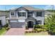 Beautiful two-story home with manicured landscaping, a brick driveway, and an inviting front entrance at 2090 Prairie Sage Ln, Longwood, FL 32750