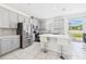 Spacious kitchen with stainless steel appliances, a center island with seating, and view to the dining area at 2090 Prairie Sage Ln, Longwood, FL 32750
