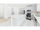 Bright kitchen featuring stainless steel appliances, white cabinetry, and a large island at 2090 Prairie Sage Ln, Longwood, FL 32750
