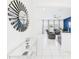 Elegant entryway with a mirrored console table leading to a cozy living room featuring comfortable reclining chairs at 2090 Prairie Sage Ln, Longwood, FL 32750