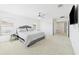 Comfortable main bedroom with large windows, TV, and light neutral carpet at 2090 Prairie Sage Ln, Longwood, FL 32750