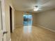 Spacious bedroom with ceiling fan, sliding glass doors to balcony and wood floors at 2200 S Palmetto Ave # C040, Daytona Beach, FL 32119