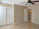 Bedroom featuring ceiling fan, closet, doorway and wood flooring at 2200 S Palmetto Ave # C040, Daytona Beach, FL 32119