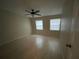 Bedroom with ceiling fan, wood floors and natural light from windows at 2200 S Palmetto Ave # C040, Daytona Beach, FL 32119
