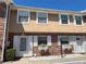 Charming townhouse featuring brick facade, white trim, and flower boxes under the windows at 2200 S Palmetto Ave # C040, Daytona Beach, FL 32119