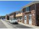 Townhouse complex with brick facade, white trim, and ample parking at 2200 S Palmetto Ave # C040, Daytona Beach, FL 32119