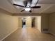 Open-concept living space with neutral tile flooring, ceiling fan, and easy access to other rooms at 2200 S Palmetto Ave # C040, Daytona Beach, FL 32119