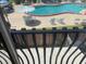 Pool view from balcony featuring blue pool water, tables and chairs at 2200 S Palmetto Ave # C040, Daytona Beach, FL 32119