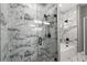 Spa-like bathroom with marble tile, glass shower doors, and modern fixtures at 226 N Frederick Ave, Daytona Beach, FL 32114