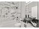 Modern bathroom with stunning marble tile, updated vanity, and contemporary fixtures at 226 N Frederick Ave, Daytona Beach, FL 32114
