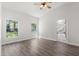 Bright bedroom with wood-look flooring, two windows, and ensuite bathroom at 226 N Frederick Ave, Daytona Beach, FL 32114