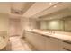 Luxurious bathroom with double vanity, granite countertop, and large mirror at 231 Riverside Dr # 1003-1, Daytona Beach, FL 32117