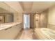 Spacious bathroom with double vanity, granite countertop, soaking tub, and glass shower at 231 Riverside Dr # 1003-1, Daytona Beach, FL 32117