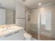 Bright bathroom featuring a tiled walk-in shower, granite vanity, and modern fixtures at 231 Riverside Dr # 1003-1, Daytona Beach, FL 32117