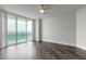 Bedroom features wood flooring, a ceiling fan, and sliding glass doors to a balcony at 231 Riverside Dr # 1003-1, Daytona Beach, FL 32117