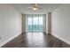 Bedroom features wood flooring, a ceiling fan, and sliding glass doors to a balcony at 231 Riverside Dr # 1003-1, Daytona Beach, FL 32117