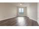 Bright bedroom with wood flooring and a large window offering city views at 231 Riverside Dr # 1003-1, Daytona Beach, FL 32117