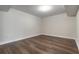 Bright bedroom with wood-look floors and a view of the outside at 231 Riverside Dr # 1003-1, Daytona Beach, FL 32117
