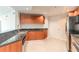 Modern kitchen with granite countertops, stainless steel appliances, and wood cabinets at 231 Riverside Dr # 1003-1, Daytona Beach, FL 32117