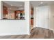 Bright entryway featuring a view of the kitchen with stainless steel appliances and hardwood floors at 231 Riverside Dr # 1003-1, Daytona Beach, FL 32117