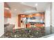 Kitchen boasts granite counters, a stainless-steel refrigerator, microwave and hardwood cabinets at 231 Riverside Dr # 1003-1, Daytona Beach, FL 32117
