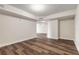 Spacious living room with wood-look floors and bright white walls at 231 Riverside Dr # 1003-1, Daytona Beach, FL 32117