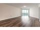 Spacious living room featuring beautiful hardwood floors and sliding glass doors to a balcony with a water view at 231 Riverside Dr # 1003-1, Daytona Beach, FL 32117