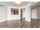 Open concept living area with hardwood floors looking into the kitchen with stainless steel appliances at 231 Riverside Dr # 1003-1, Daytona Beach, FL 32117