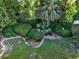 Overhead shot of meticulously landscaped backyard with lush lawns, hedges, and mature trees creating privacy at 232 Westchester Dr, Deland, FL 32724