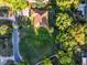 Aerial shot capturing this home in its neighborhood with its trees, lawns, and proximity to the street at 232 Westchester Dr, Deland, FL 32724