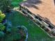 Aerial view of a well-maintained backyard with green grass, garden beds, and mature trees at 232 Westchester Dr, Deland, FL 32724