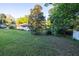 Lush backyard showcasing mature trees and landscaping, offering privacy and a serene outdoor space at 232 Westchester Dr, Deland, FL 32724