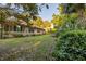Beautiful backyard with mature trees, landscaping, and a well-kept lawn, ideal for relaxation and outdoor enjoyment at 232 Westchester Dr, Deland, FL 32724