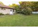 Spacious backyard featuring a well-maintained lawn and mature trees, perfect for outdoor activities at 232 Westchester Dr, Deland, FL 32724