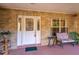 Close up of the front porch with brick accents, seating, and a decorated front door at 232 Westchester Dr, Deland, FL 32724