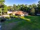 Overhead of a single Gathering home featuring a driveway, green lawn, and mature trees at 232 Westchester Dr, Deland, FL 32724