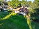 Aerial view displaying the home, front yard, green lawn and mature trees at 232 Westchester Dr, Deland, FL 32724