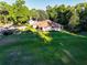 Aerial view capturing a charming home with a well-manicured front lawn and mature trees at 232 Westchester Dr, Deland, FL 32724