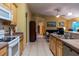 Open kitchen with wood cabinets, tile floors and view into another room of the house at 232 Westchester Dr, Deland, FL 32724