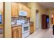 Charming kitchen with wood cabinets, and white appliances at 232 Westchester Dr, Deland, FL 32724